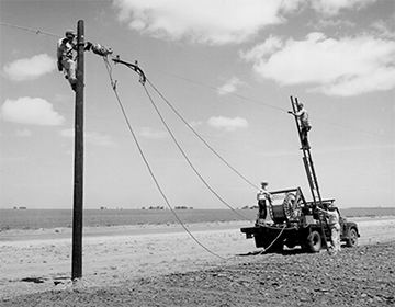 Rural Electrification Administration (REA) erects telephone lines in rural areas. Photo courtesy of National Archives and Records Administration.